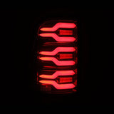AlphaRex 19-21 Dodge Ram 1500 Luxx-Series LED Tail Lights Black/Red w/Activ Light/Seq Signal 640050